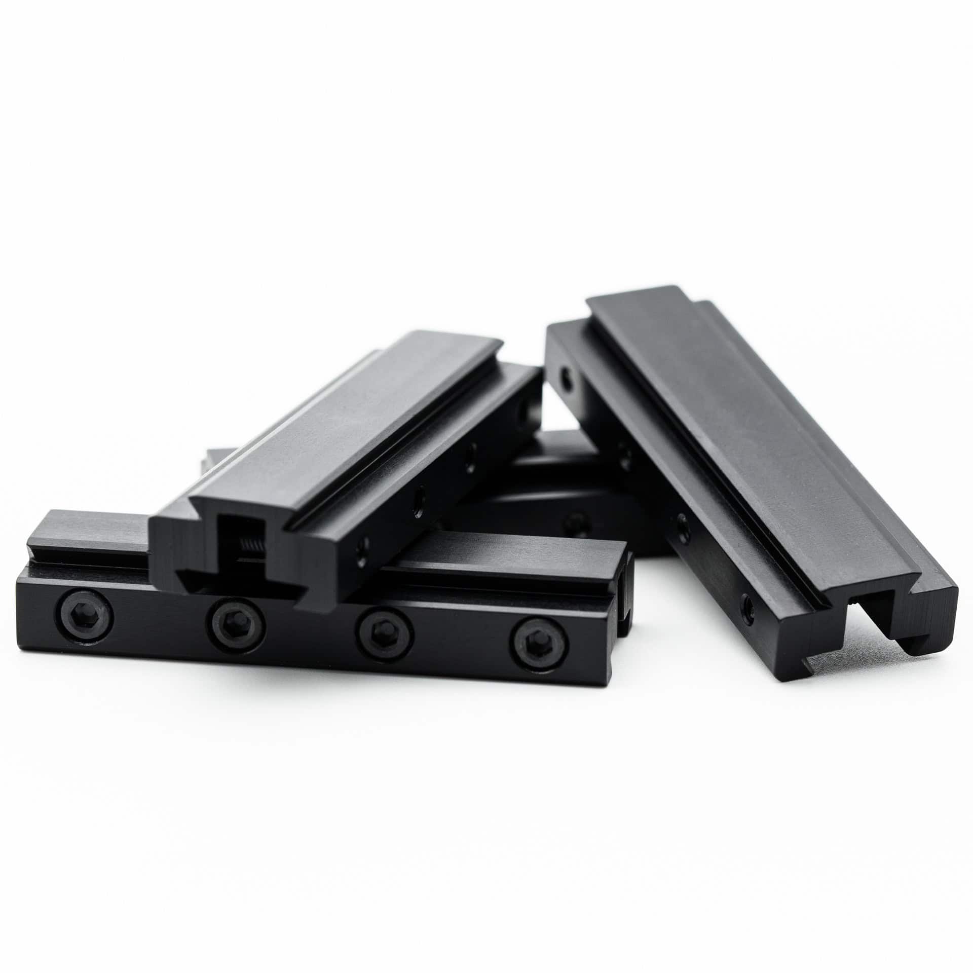 Fortner 8mm rear sight risers for Anschutz 1827F biathlon rifles piled in multiple orientations